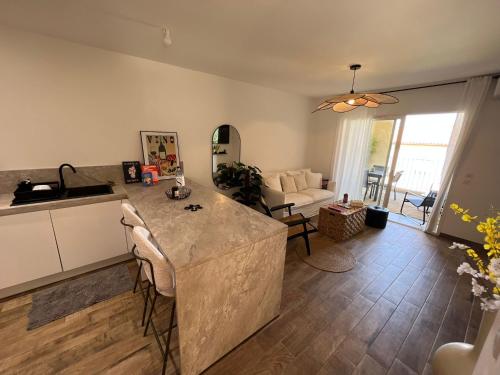 a kitchen and living room with a counter top at Appartement neuf, proche des plages et centre ville in Saint-Florent