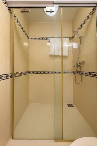 a shower with a glass door in a bathroom at LuxuryK&T Hotel-Near Bùi Viện Walking Street in Ho Chi Minh City