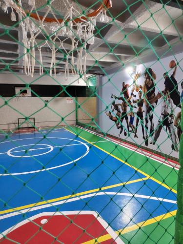 a group of people playing a game of basketball on a court at La Dolce Vita in Maceió