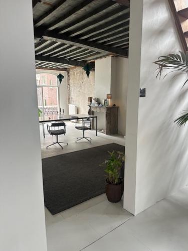 an open doorway to a room with a table and chairs at Cloud9 in Bergen op Zoom