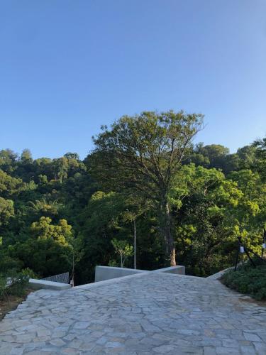 a stone road with a tree in the distance at 大梅石創生共享家士兵館 in Ma-tsu Tao