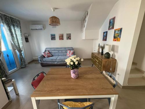 a living room with a table and a couch at La Dimora del Salento in Torre Lapillo