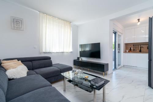 a living room with a couch and a table at Apartment Cvit in Trogir