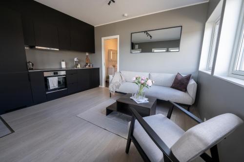 a living room with a couch and a table at Steam Apartments - Eidhøgda 6 in Tromsø