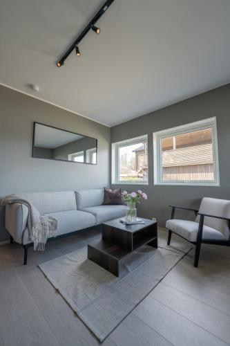 a living room with a couch and a table at Steam Apartments - Eidhøgda 6 in Tromsø