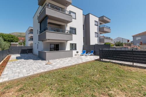 a building with a lawn in front of it at Apartment Cvit in Trogir