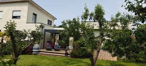 a white house with a porch and a yard at Maison avec Spa en bord de mer in Logonna-Daoulas