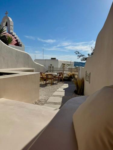 a view of a patio with benches and a building at Conte Mykonos II in Aggelika