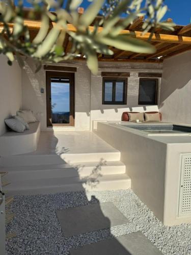 a room with stairs and a window in a building at Conte Mykonos II in Aggelika