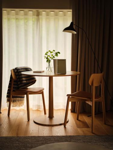a room with a table and a chair and a lamp at Fowlescombe Farm in Ugborough