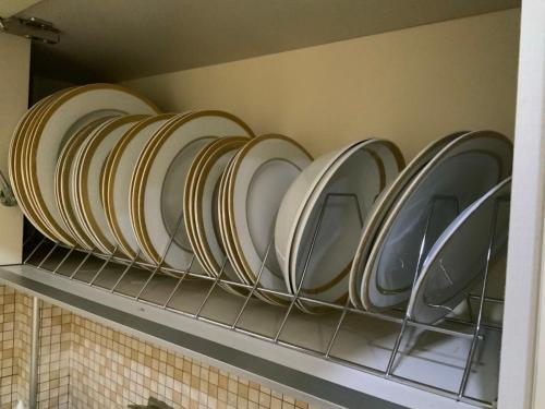a row of plates on a shelf in a kitchen at Alexandra Luxury Apartment in Alexandroupoli