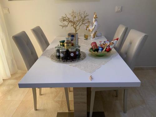 a white table with a bowl of food on it at Alexandra Luxury Apartment in Alexandroupoli