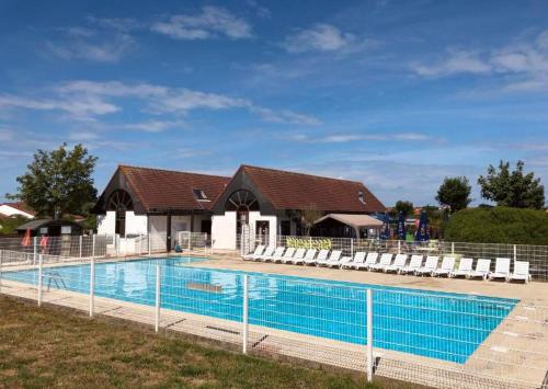 a swimming pool in front of a house at Villa 6 pers De Haan with warm swimming pool access in De Haan