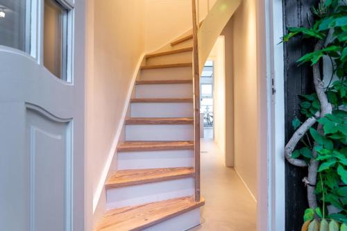 a staircase in a house with wooden steps at Strandhytten in Ålsgårde