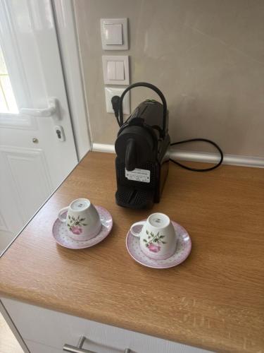 two tea cups on a counter with a coffee maker at Elena's studio in Katokhí