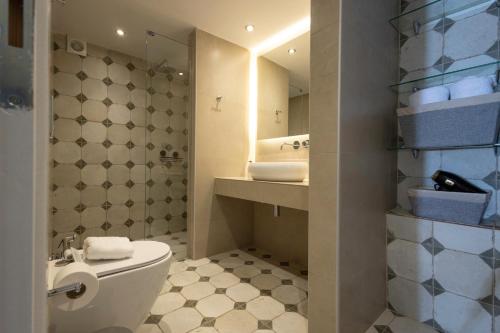 a bathroom with a white toilet and a sink at Sophia Areopoli Town Square in Areopolis