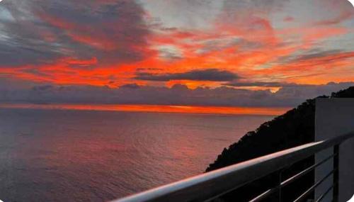 a view of the ocean with a red sunset at "Belvédère de la Mer" Résidence "Icaros" Wifi-Piscine-Pkg in Begur