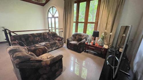 a living room with two couches and a couch at Sweet Villa Hotel in Peradeniya