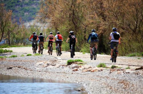 a group of people riding bikes down a dirt road at Hotel Rajna in Starigrad-Paklenica