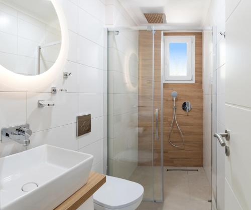 a bathroom with a shower and a toilet and a sink at Apartment Chrisi in Skala Potamias