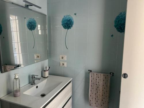 a bathroom with a sink and a mirror at twins home in Castiglione della Pescaia
