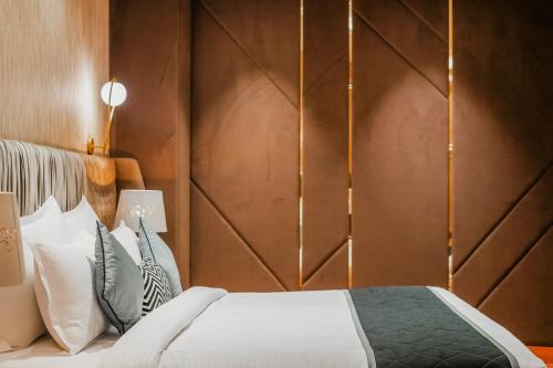 a bedroom with a bed and a wooden wall at Quality Inn Elite Levelup Boutique in Amritsar