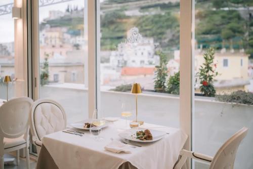 a white table with plates of food on top of a window at Minori Palace in Minori