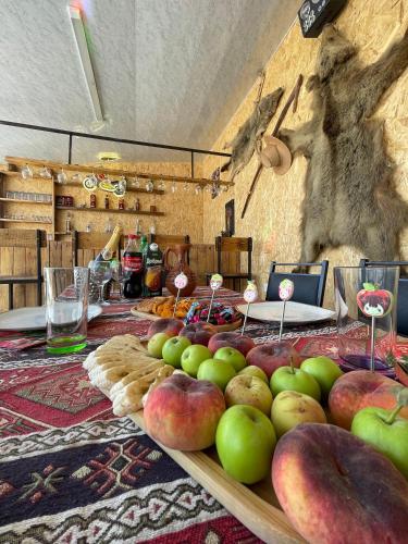 a table with apples and other fruits on it at Zvartnots House in Ejmiatsin