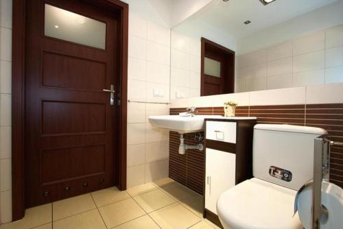 a bathroom with a toilet and a sink at Apartamenty Przymorze in Gdańsk