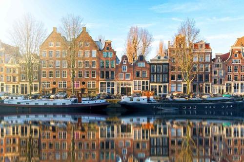 a group of buildings and boats on a canal at Private Tiny House in Bussum near Amsterdam! in Bussum