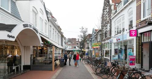 a group of people walking down a city street at Private Tiny House in Bussum near Amsterdam! in Bussum