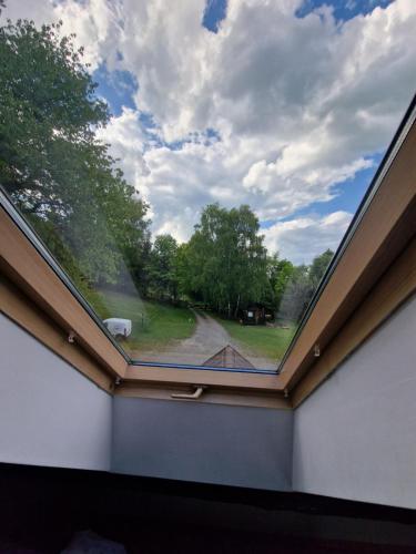 a large window in a room with a roof at Apartament Buczyna in Brenna