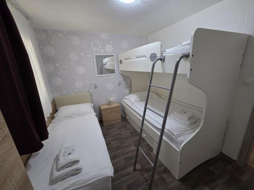 a small room with two bunk beds and a mirror at Lavanda Mobile Homes & Villas in Orebić