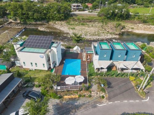 an aerial view of a house with solar panels on it at Dalgrin Pension Gapyeong in Gapyeong