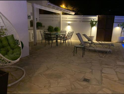 a patio with chairs and a table and chairs at Elysian Villa in Larnaka
