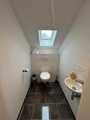 a small bathroom with a toilet and a sink at Wienerwald Juwel in Irenental
