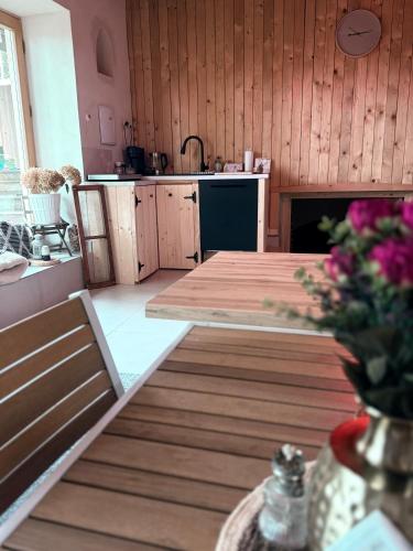 a kitchen with a wooden table and a counter top at Ubytování TradiceJinak in Dolní Dunajovice