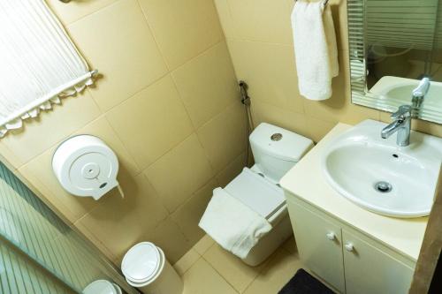 a bathroom with a sink and a toilet at Stela Garden Villas in Compostela