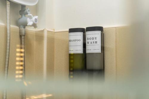 two bottles of wine on a shelf in a room at Stela Garden Villas in Compostela