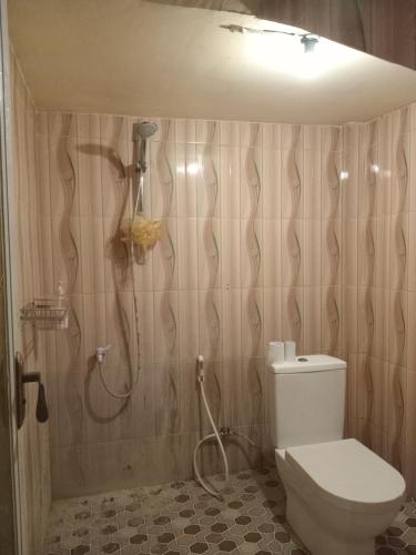 a bathroom with a shower and a toilet at PENDIK Home Stay in Labuan Bajo
