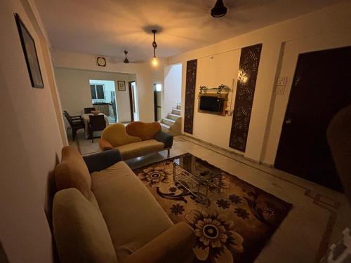 a living room with a couch and a table at Spacious 3 BHK Villa, Lonavala in Lonavala