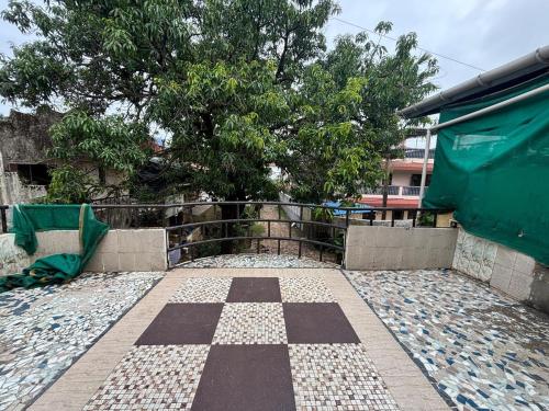 a checkered floor in front of a building at Spacious 3 BHK Villa, Lonavala in Lonavala