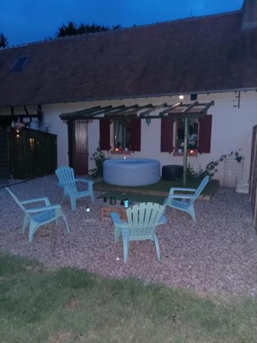 a group of chairs and a tub in a yard at Le Blue Dream Arcade Bain à bulles in Ladon