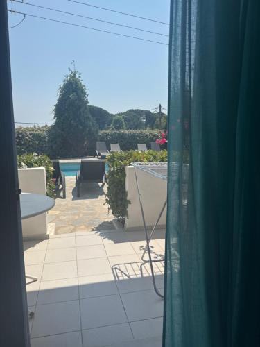 a room with a view of a patio with a window at Esperos Apartments&Studios in Troulos