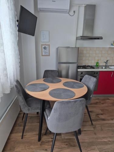 a kitchen with a table and chairs in a kitchen at Apartmani Hršak in Krapina