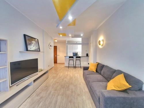 a living room with a couch and a flat screen tv at Terrace between Rome and the sea in Vitinia