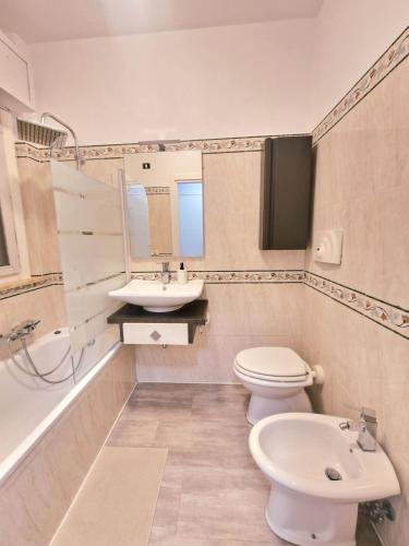 a bathroom with a toilet and a sink and a tub at Terrace between Rome and the sea in Vitinia