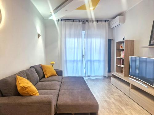 a living room with a couch and a television at Terrace between Rome and the sea in Vitinia
