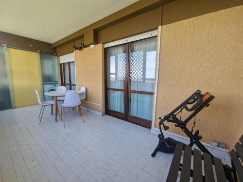 a room with a table and chairs and a window at Terrace between Rome and the sea in Vitinia