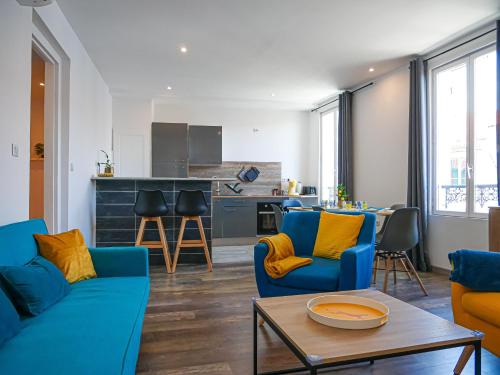 un salon avec des canapés bleus et une cuisine dans l'établissement Immeuble complet Casa Bella & Divina, à Thiers